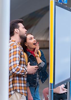 Two people reading wayfinding signage